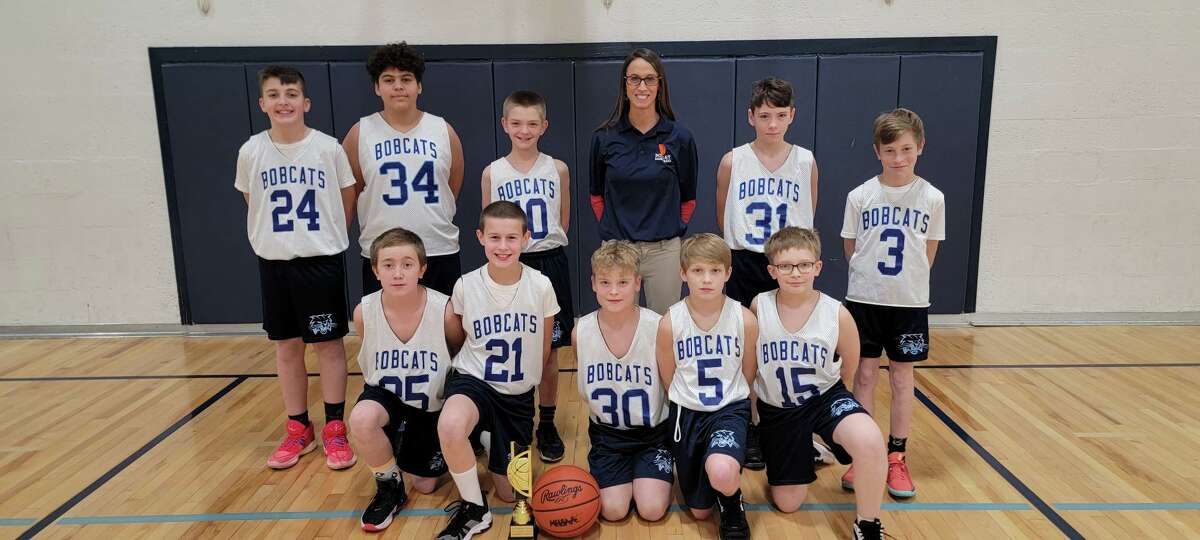 The Brethren seventh grade boys basketball team poses for a photo. Front row (left to right): Evan Wilson, Knox Schmidt-Stoykovich, Ryder Girven, Carter Pete, David Golebiweski. Back row (left to right): Harrison Estes, Isaiah Howes, Connor Maylone, Coach April Schmidt-Benson, Christopher Rose, Cody Morrison