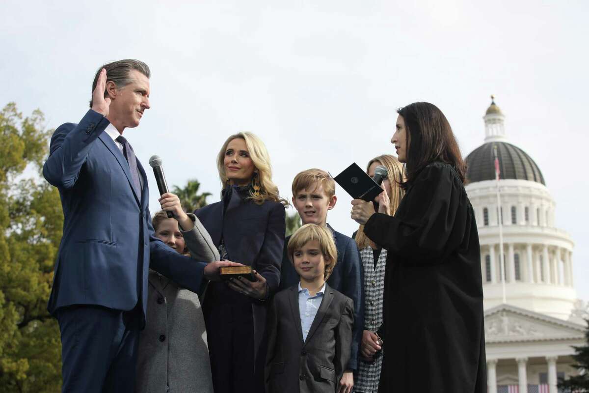 Newsom, standing with his family at the state Capitol, is sworn in to office for a second term.