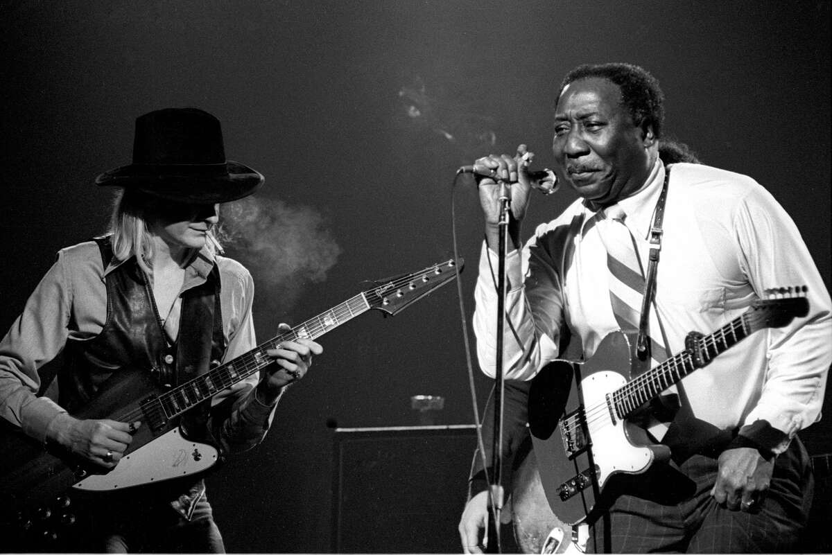 Blues guitarists Johnny Winter and Muddy Waters perform on stage, New York, 1977.