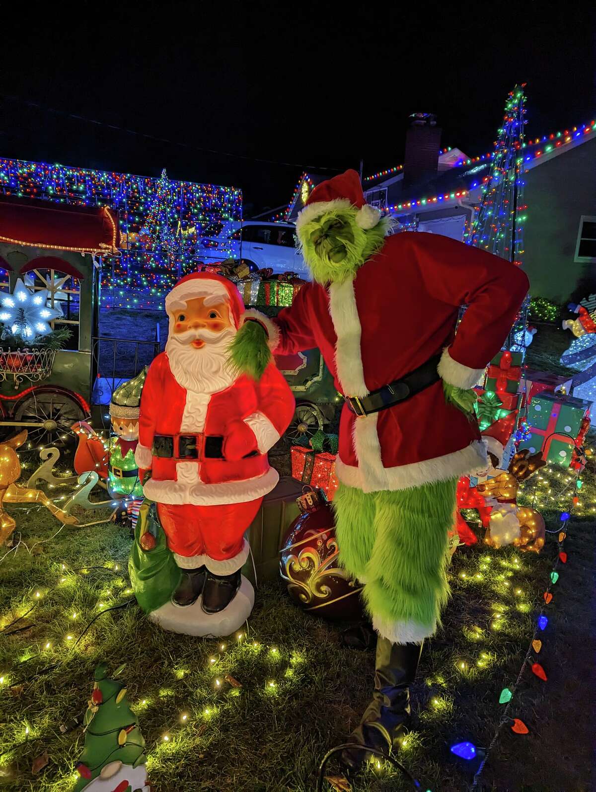 Santa and the Grinch at the main fundraising display for the Sterling Road/Santa's Runway light display in Trumbull. 