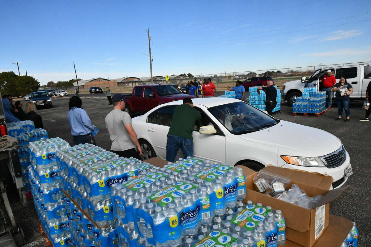 Volunteers help distribute water and meals for kids Friday, Jan. 6, 2023 at the water distribution center at Martin Luther King Jr. Community Center.