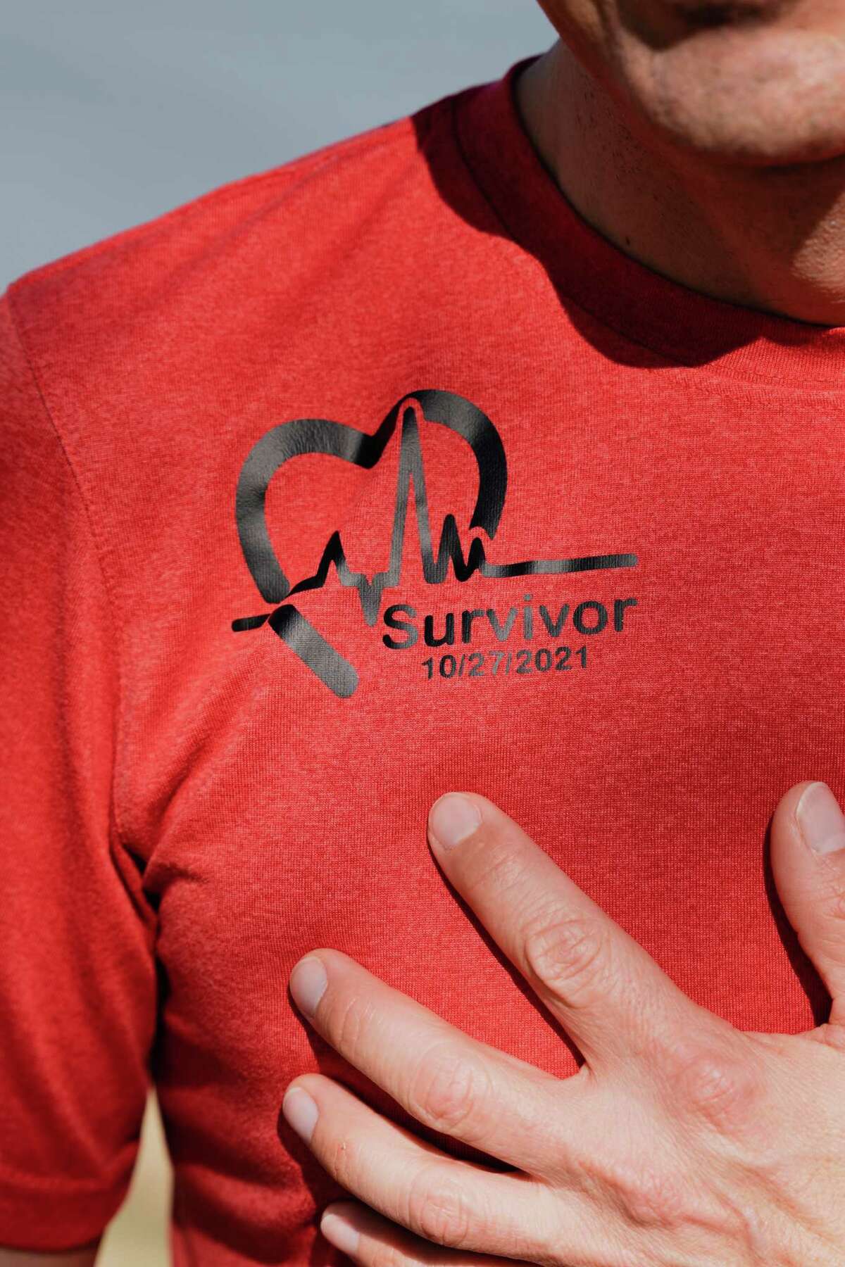 Esau Velazquez shows off his shirt, “Survivor, 10/27/2021” in Houston, Friday, Jan. 6, 2023. Velazquez recently suffered a heart attack last year and has enroll in Memorial Hermann's cardiac rehab program to get back to running.