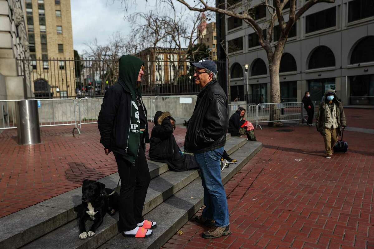 Thumper, 26, a homeless drug user, chats with author Sam Quinones at Civic Center Plaza in San Francisco.