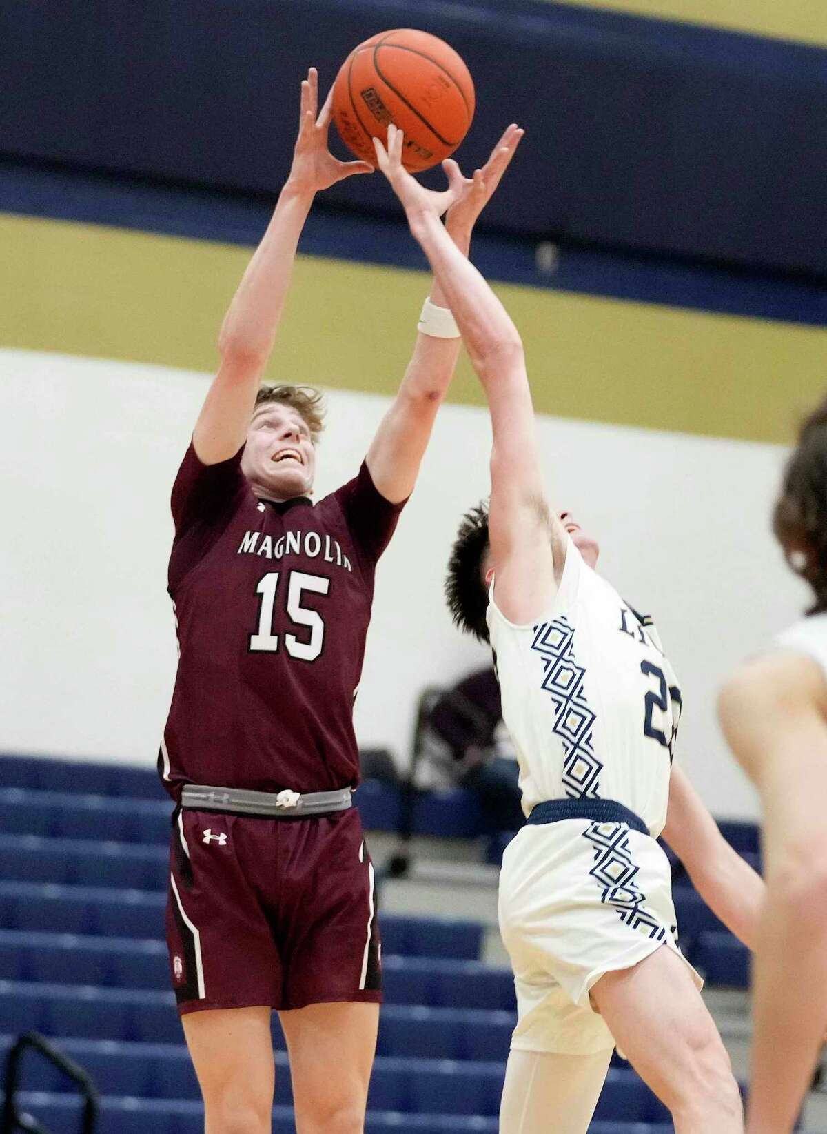 Magnolia guard Tyler Podhalski (15) and Lake Creek guard Braedon Bigott leap for a pass during the second half of a high school basketball game, Friday, Jan. 6, 2023, in Montgomery.