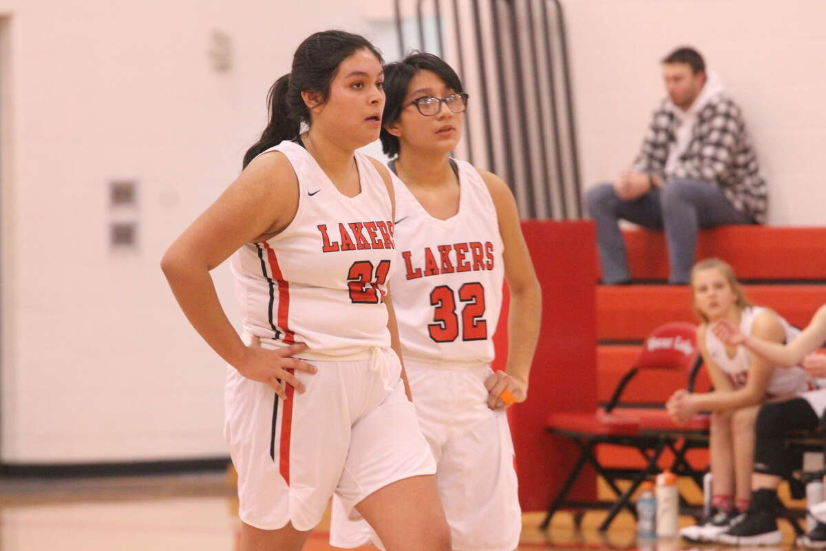 Bear Lake's Conzuelo Magana Garcia (left) and Dafne Yanez Chavez (right) converse while a teammate shoots free throws on Jan. 6. 
