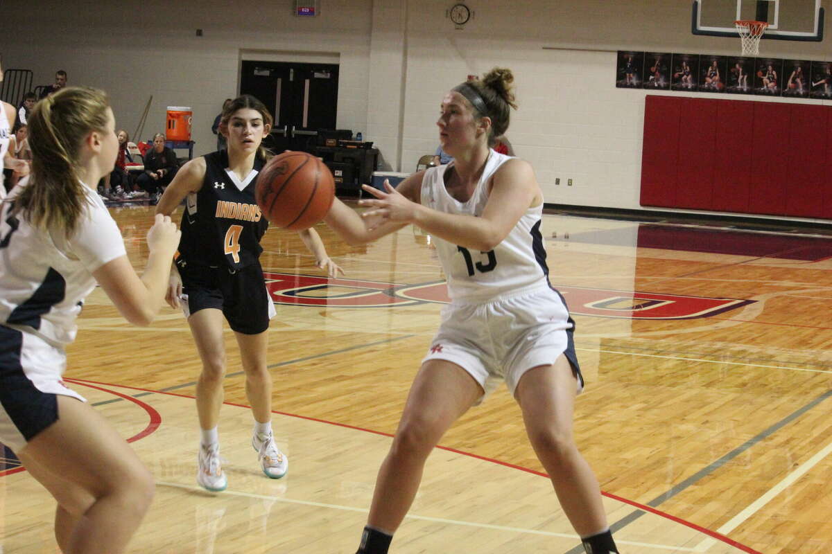 Big Rapids' Rylie Haist (right) passes the ball to Hadley Fox during Friday's girls basketball game.