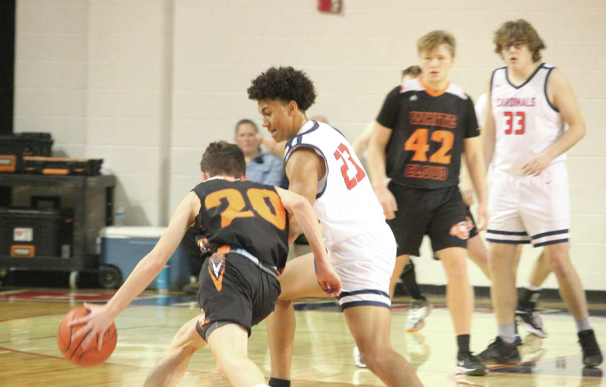 Big Rapids' Zander Prince (23) applies the defensive pressure against White Cloud's Kevin Strait (20) on Friday.