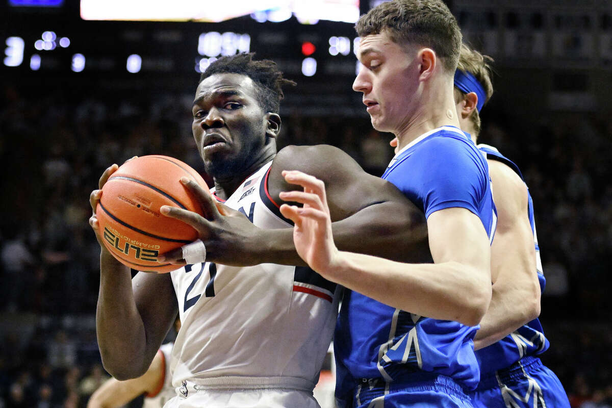Connecticut's Adama Sanogo, left, is guarded by Creighton's Ryan Kalkbrenner in the first half of an NCAA college basketball game, Saturday, Jan. 7, 2023, in Storrs, Conn. (AP Photo/Jessica Hill)