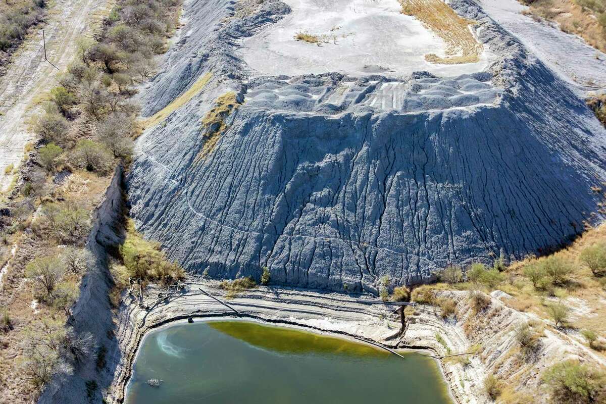 An apparent pile of coal ash at a former lignite mine site is seen Dec. 27, 2022, near the San Miguel Electric Cooperative’s 400-megawatt, lignite coal-fired power plant.