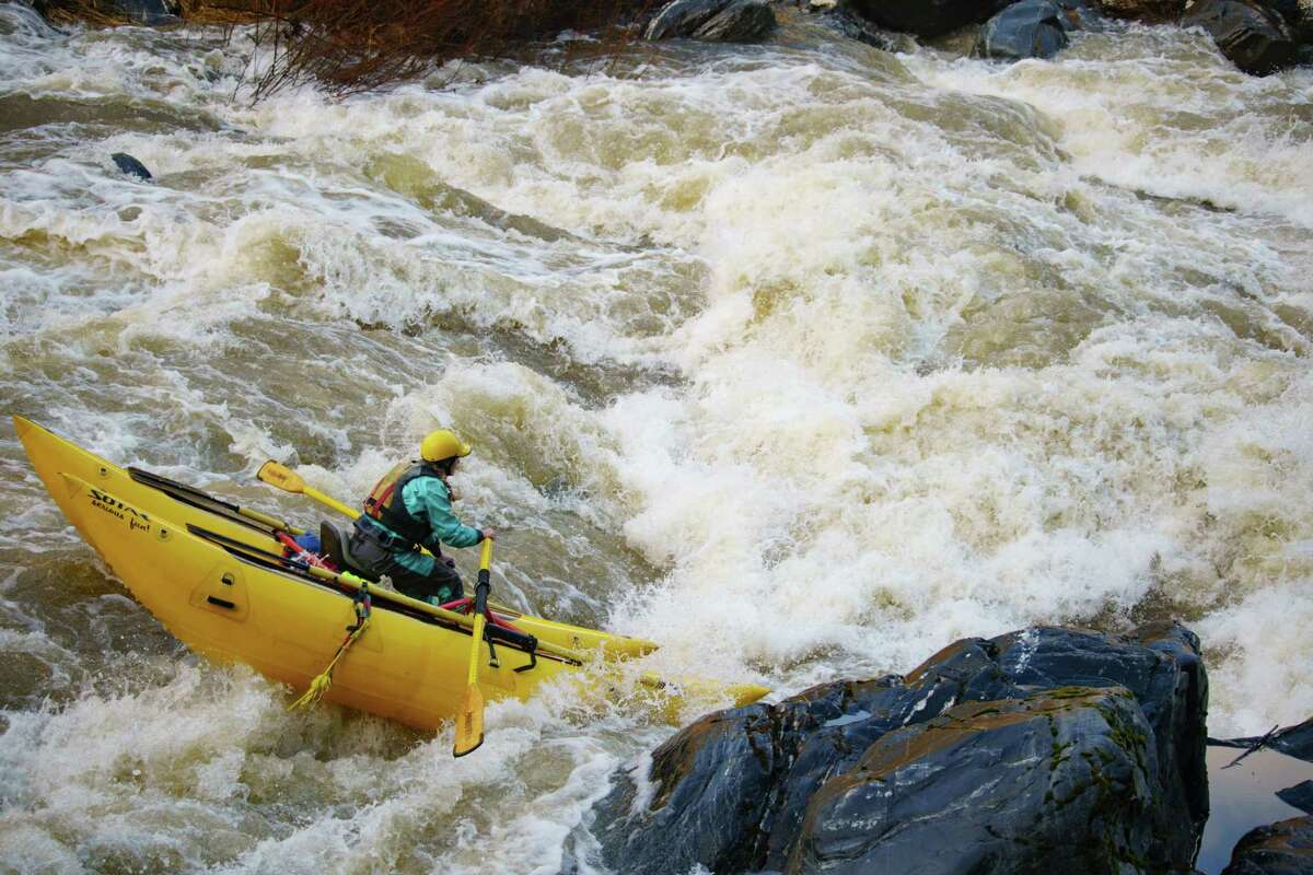 Nicole Smedegaard paddles her cataraft down the Scott River in Siskiyou County during a surge in December.
