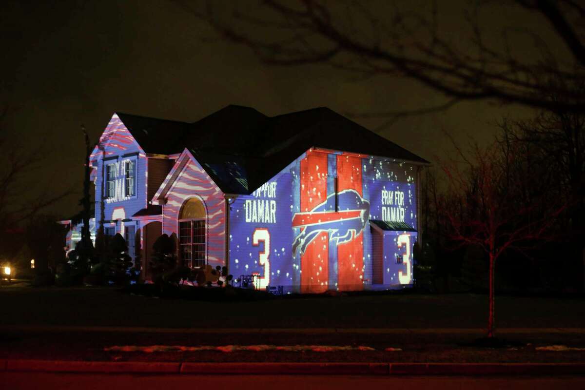 A projection showing support for Buffalo Bills safety Damar Hamlin is seen on Michael and Shauna Karas' house Friday, Jan. 6, 2023, in Lancaster, N.Y. Hamlin is now breathing and walking on his own, and traded in the writing pad he had been using to communicate.
