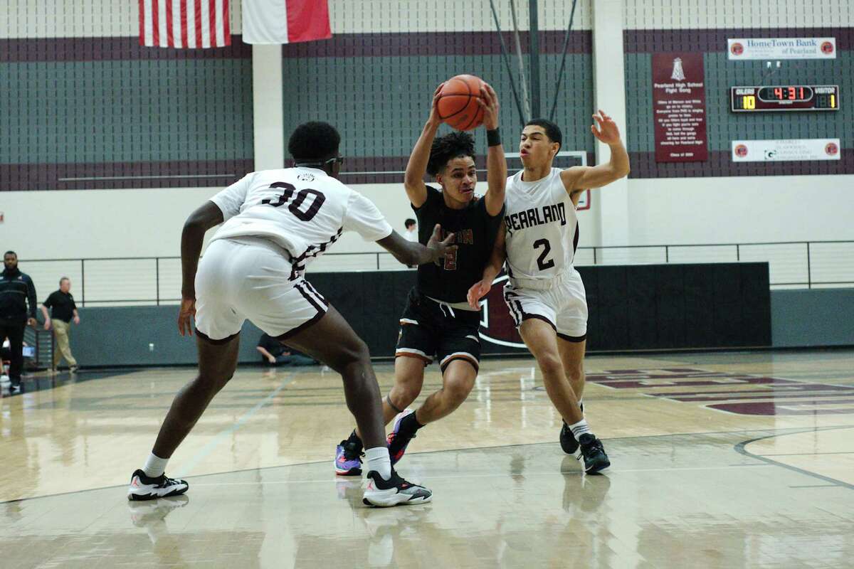 Alvin’s Jacob Cao (2) is guarded closely by Pearland’s Ezenna Ibe (30) and Pearland’s Ryan Spears (2) Saturday, Jan. 7, 2023 at Pearland High School.