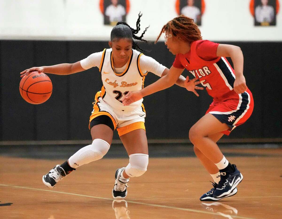 Hasting High School's Abrielle Grissett (21) works against Alief Taylor's Cyndol Davis (5) during the first half of a District 23-6A girls basketball game at Hastings High School on Saturday, Jan. 7, 2023 in Houston.