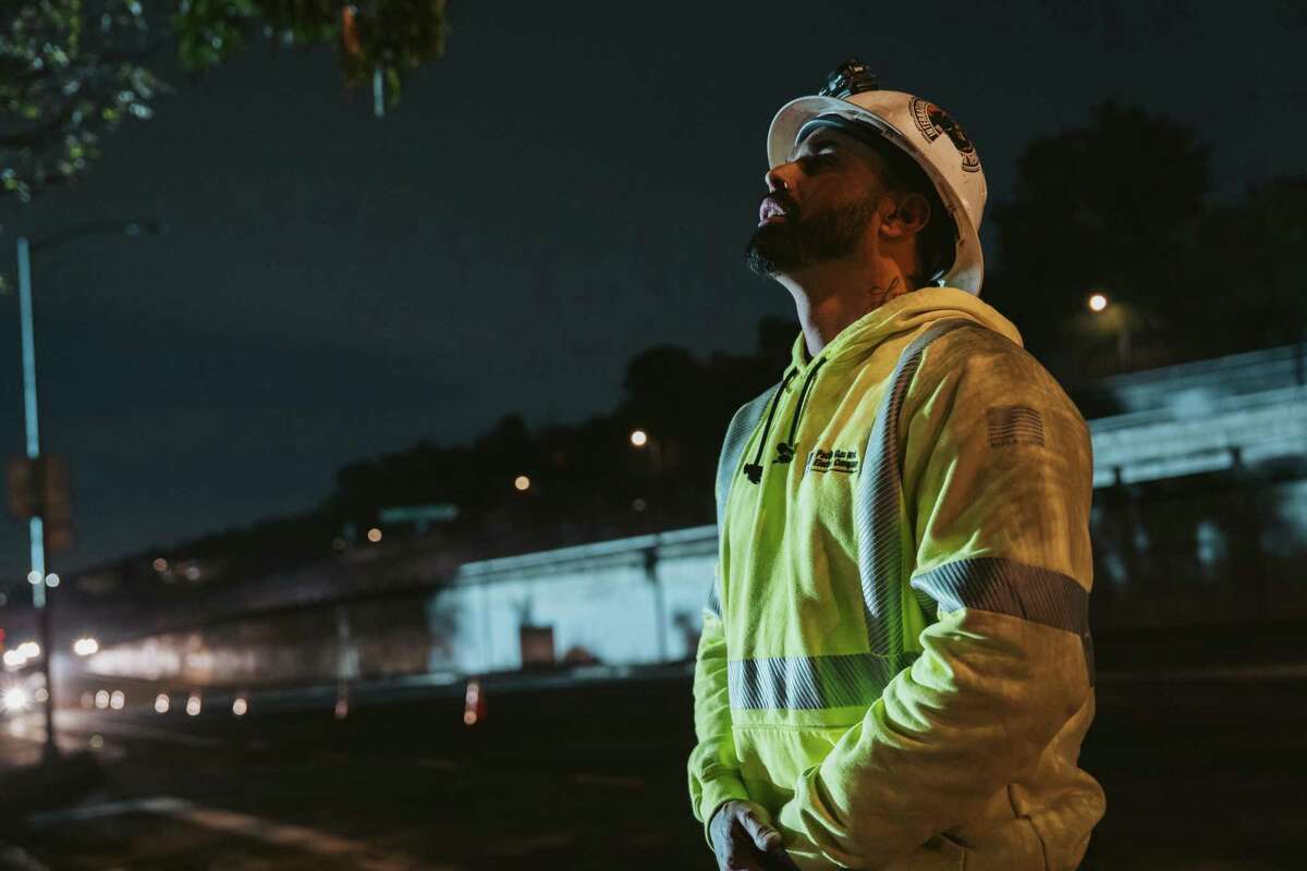 PG&E crew foreman Ryan Rodriguez oversees work on damaged power lines late on Friday night. “We’re not going home until we finish,” he said. Rodriguez anticipated that St. Mary’s Park would regain power around midnight.