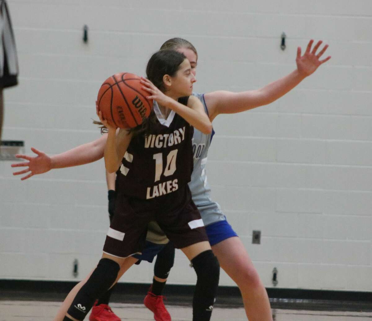 Victory Lakes player Maryssa Martinez (10) finds her progress on the court blocked by a Friendswood defender during Saturday's 8B title contest of the San Jacinto Invitational.