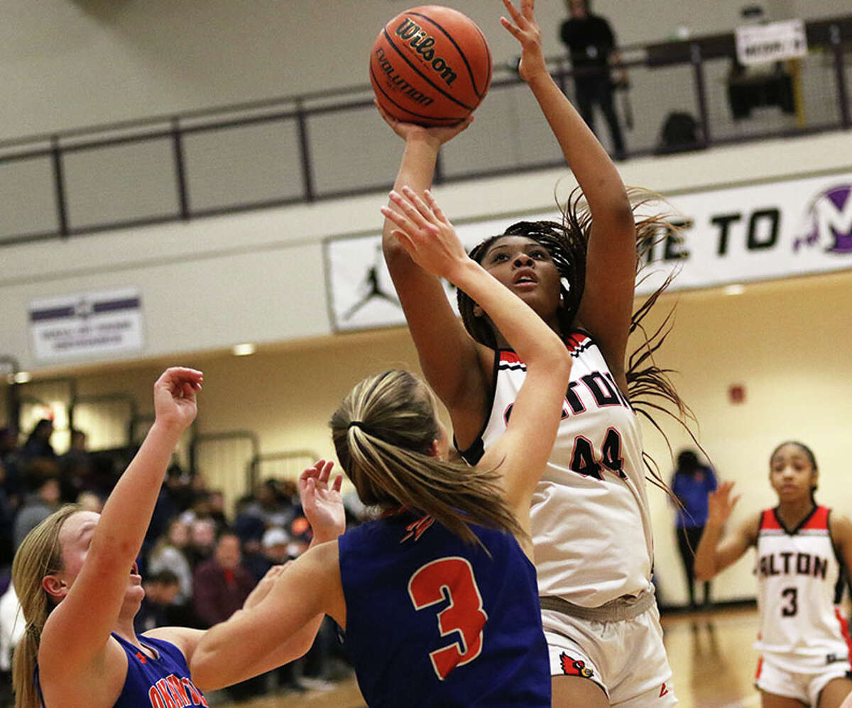 Alton's Jarius Powers shoots over Okawville's Megan Rennegarbe (3) in a December game at the Mascoutah Tourney. On Saturday, Powers was named the Player of the Game in the 17-0 Redbirds victory at the Grow The Game Shootout in Naperville.
