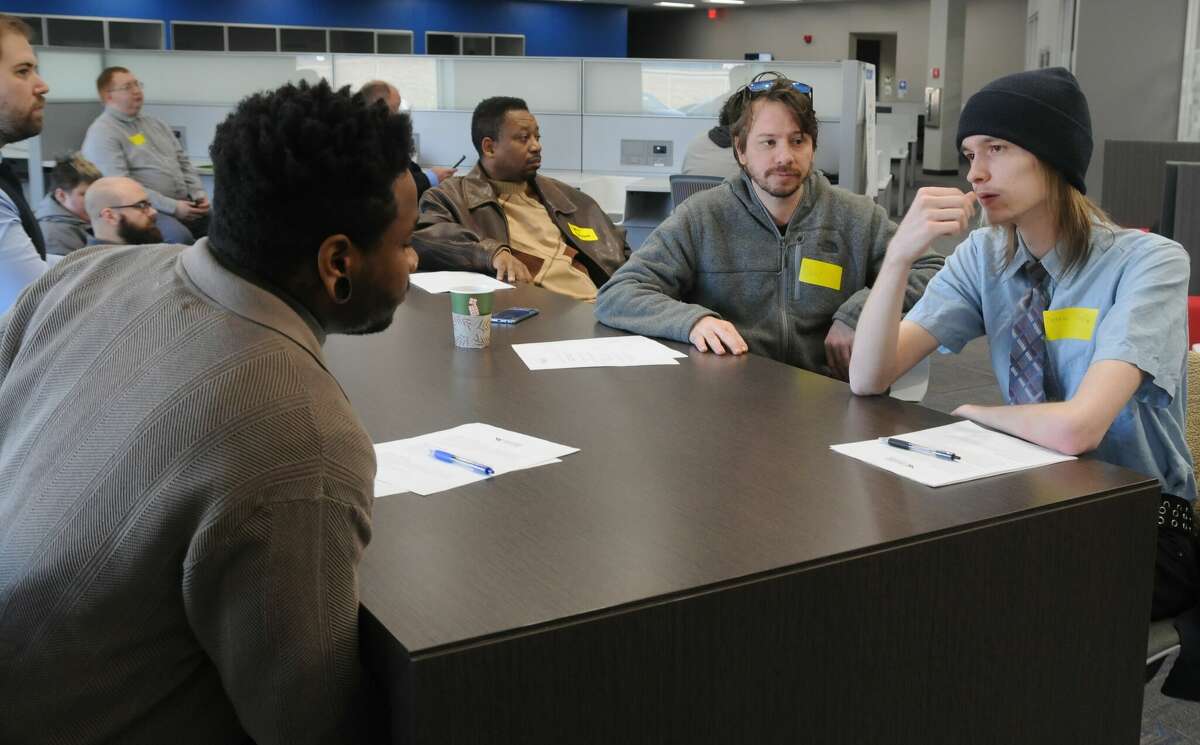Job applicants talk while waiting to be called for interviews during Saturday's World Wide Technology job fair at the firm's North American Integration Center near Edwardsville. The company hosted a job fair with the intention of filling hundreds of positions.