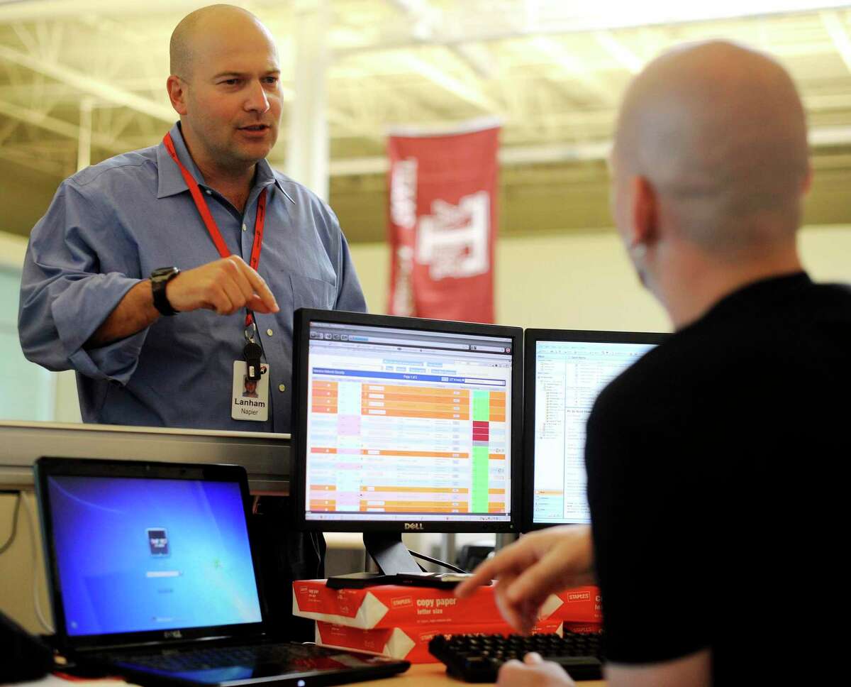 Lanham Napier, then-CEO of Rackspace Hosting Inc., chats with employee Jon Gilye at in the company's headquarters in 2010.