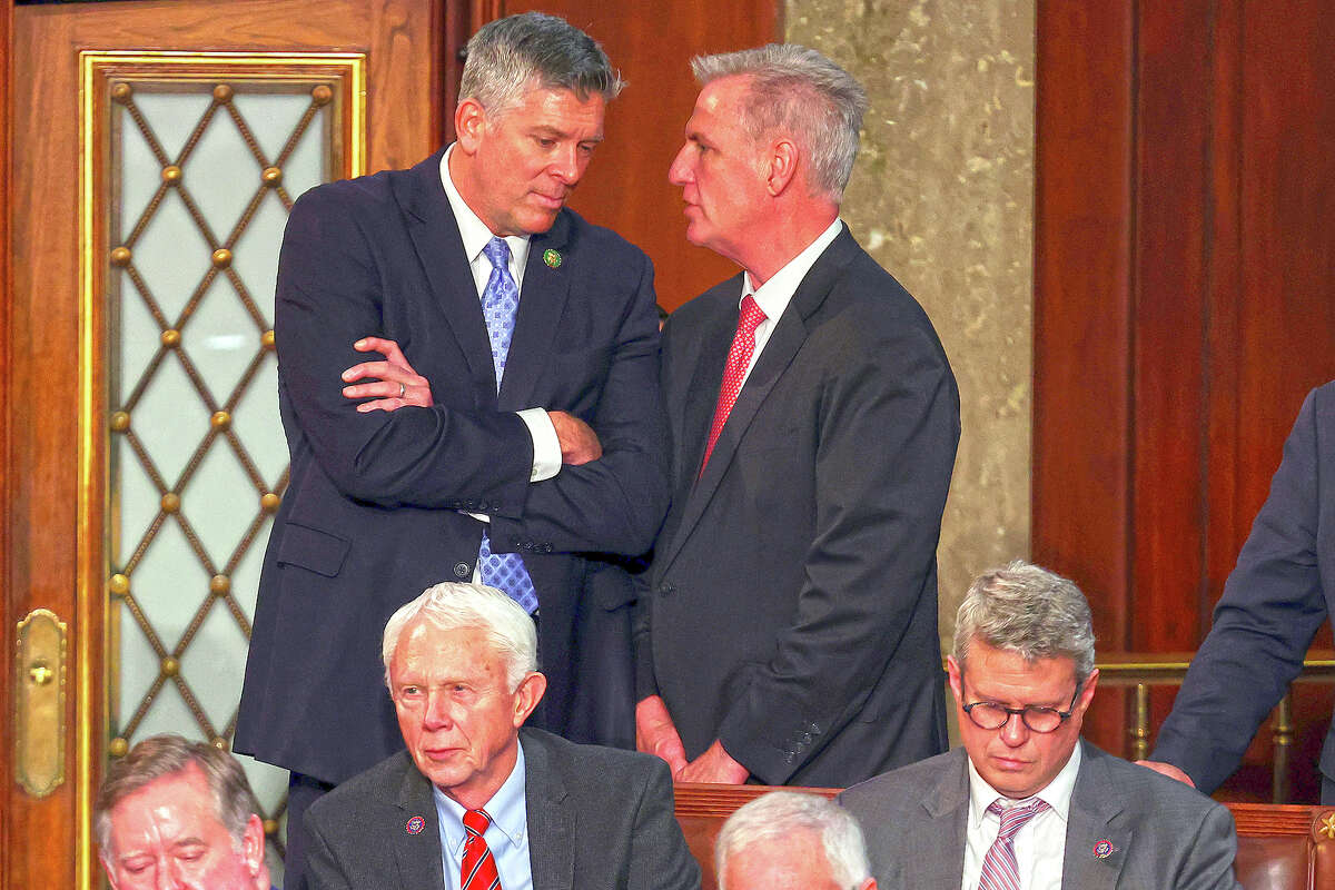 U.S. House Republican Leader Kevin McCarthy (right) talks to Rep. Darin LaHood, R-Illinois, in the House chamber.