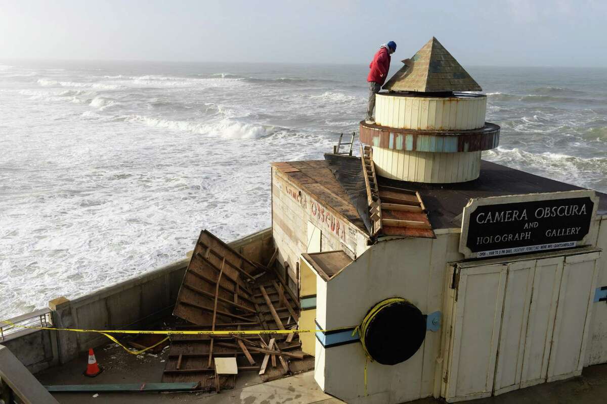 Owner-operator Robert Tacchetto makes repairs to the Camera Obscura in S.F. before rain returns.