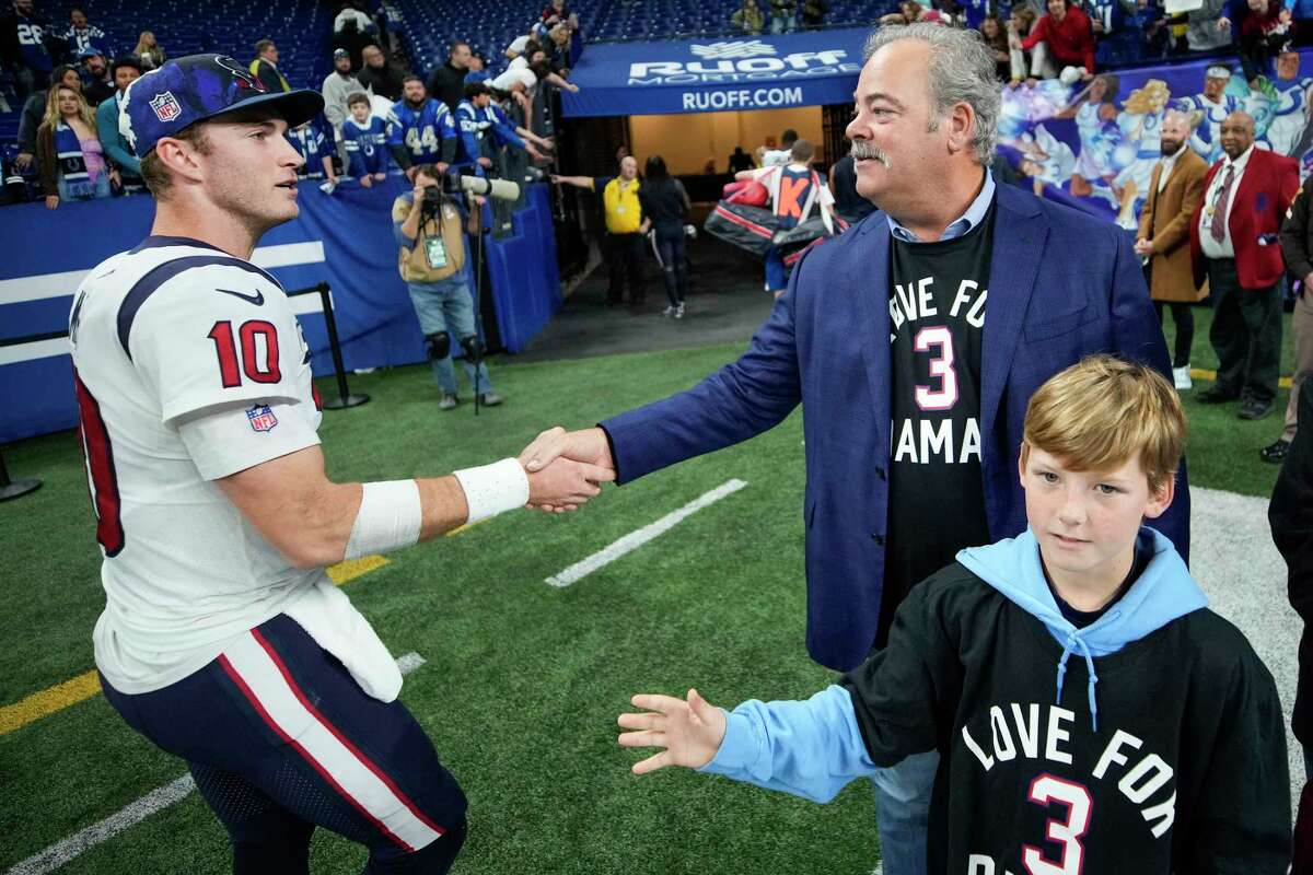 Houston Texans quarterback Davis Mills (10) shakes hands with Texans CEO Cal McNair as he leaves the field following the Texans 32-31 win over the against the Indianapolis Colts on Sunday, Jan. 8, 2023, in Indianapolis.