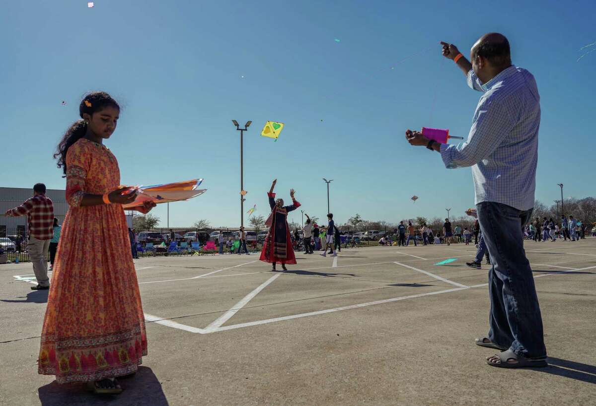 Thilak and Sree Surapanemi fly kites with their daughter Greeshma Surapanemi,9, during the Festival of Makar Sankranti on Sunday, Jan. 8, 2023 in Houston. Sankranti is a celebration of the deity Surya, the Sun, so it is tradition to fly kites, as it is meant to bring one closer to heaven.