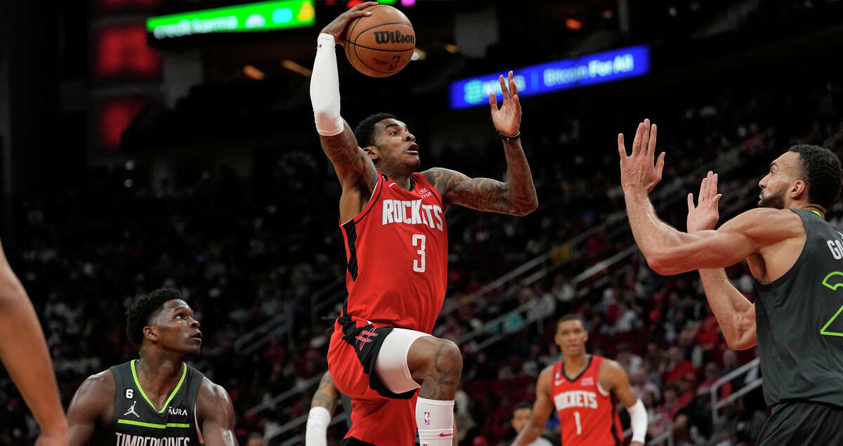 Houston Rockets' Kevin Porter Jr. (3) goes up for a shot as Minnesota Timberwolves' Rudy Gobert, right, defends during the second half of an NBA basketball game Sunday, Jan. 8, 2023, in Houston. The Timberwolves won 104-96. (AP Photo/David J. Phillip)