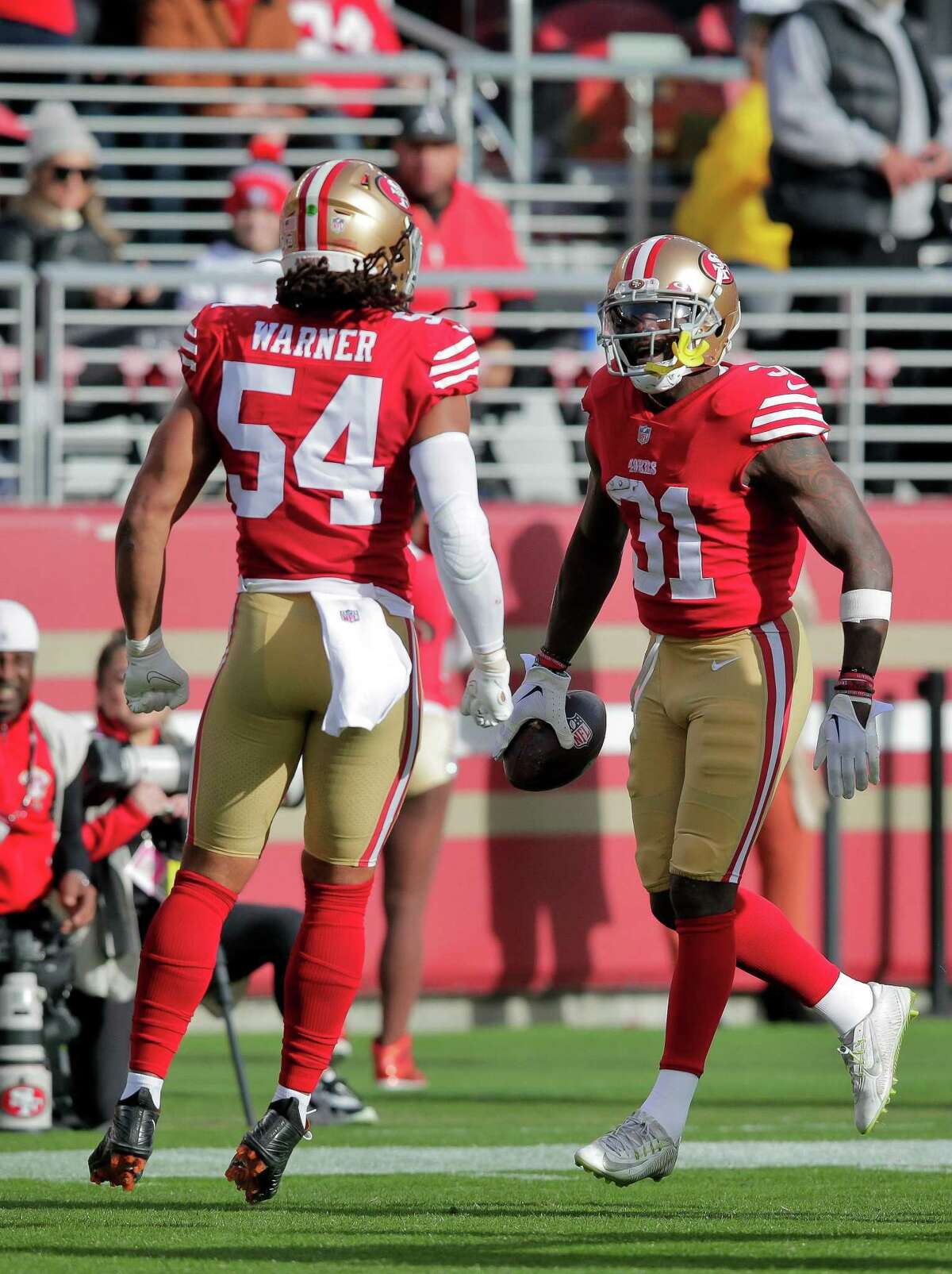 Fred Warner (54) and Tashaun Gipson (51) celebrated Gipson’s interception in the first half as the San Francisco 49ers played the Arizona Cardinals at Levi’s Stadium in Santa Clara, Calif., on Sunday, January 08, 2023.