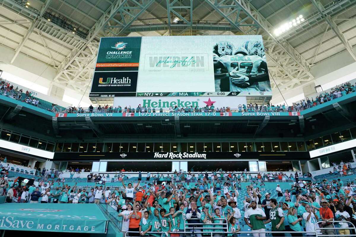 Miami Dolphins fans cheer as the team defeats the New York Jets during an NFL football game, Sunday, Jan. 8, 2023, in Miami Gardens, Fla. The Dolphins defeated the Jets 11-6 to advance to the playoffs (AP Photo/Lynne Sladky)