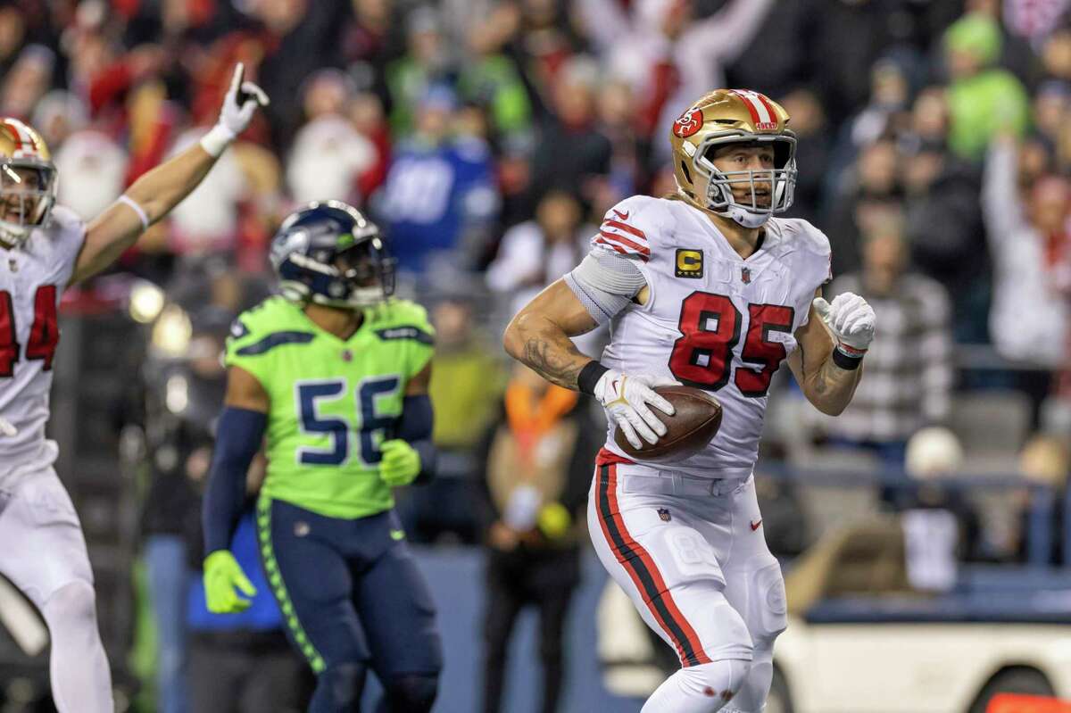 San Francisco 49ers tight end George Kittle (85) catches a pass and runs for a touchdown against the Seattle Seahawks in an NFL football game, Thursday, Dec. 15, 2022, in Seattle, Wash. 49ers won 21-13. (AP Photo/Jeff Lewis)