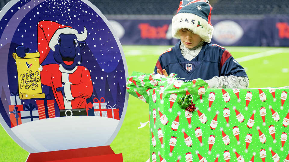 Story photo for Texans' Santa TORO surprises a Kingwood boy with special needs.