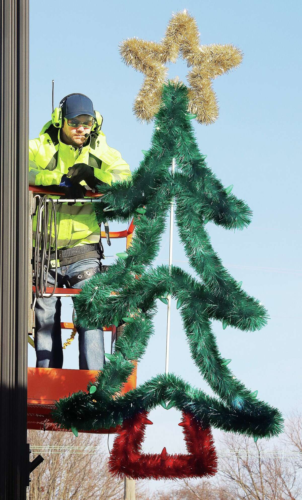 John Badman|The Telegraph Roxana Public Works employees took advantage of Monday's sunshine to remove the village's Christmas decorations on Central Avenue. Temperatures will be more moderate this week with highs forecast in the mid to upper 50s through Wednesday.