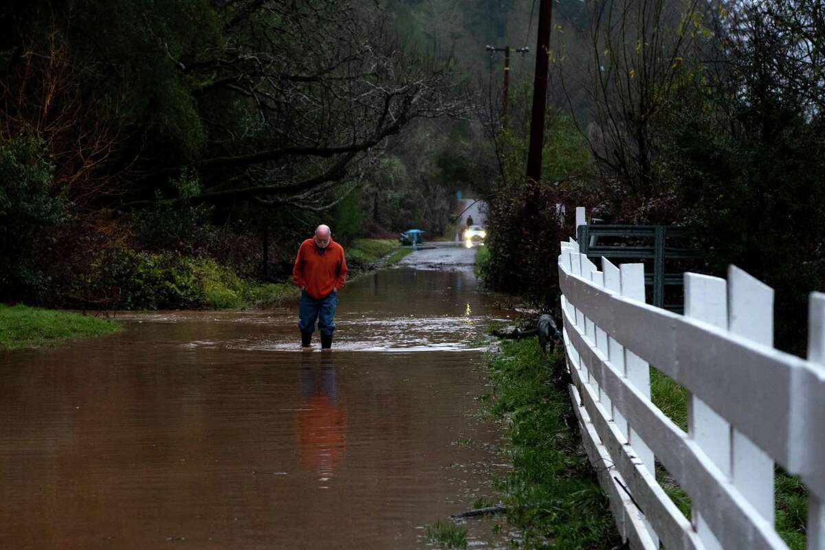 Bob Maddison walks through water on a flooded Giovanetti Rd. to check the water height in Forestville, Calif. on Monday, Jan 09, 2023. Rain in Sonoma County is expected between 10 p.m. tonight and 4 a.m.