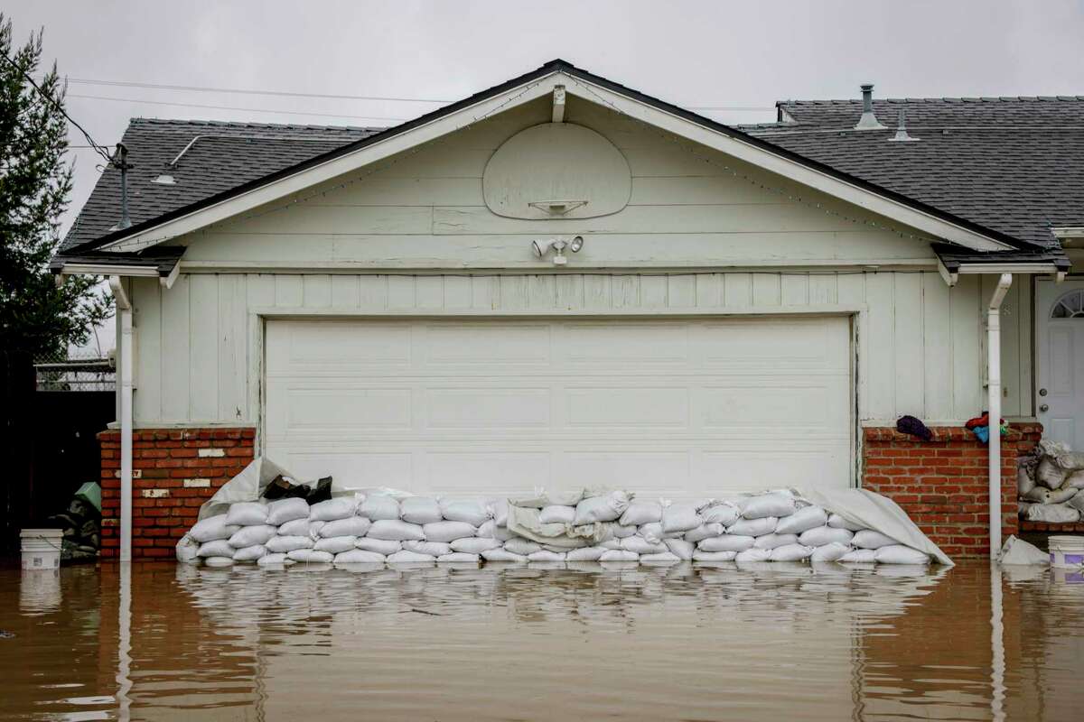 Sand bags surround the home of Daniel and Colleen Kumada-McGowan in a neighborhood off of Holohan Road near Watsonville, Calif. on Monday, Jan. 9, 2023.