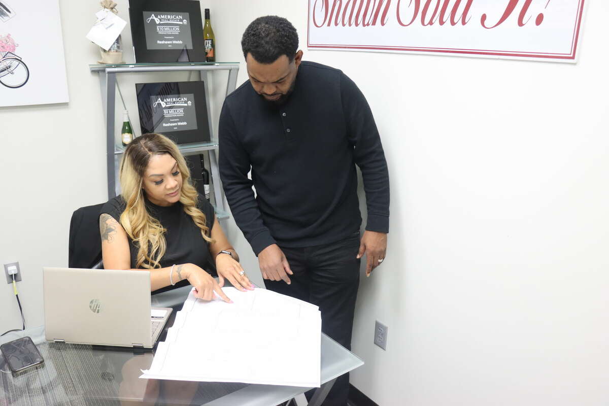 Rashawn "Shawn" Webb-Locke, who oversees the Shawn Sold It Real Estate Team, and her husband James Locke, who owns Redeem Construction, look at a property floor plan on Monday, Jan. 9, 2023.