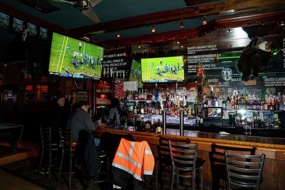 Patrons at The Four Deuces bar watch football in San Francisco, Calif. on Saturday, January 8, 2023