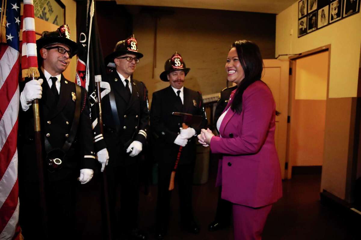 Oakland Mayor-elect Sheng Thao converses with Oakland Firefighters as they stand backstage at the Paramount Theatre for her Inauguration Ceremony on Monday, January 9, 2023, in Oakland, Calif. Thao becomes Oakland’s first Hmong mayor.