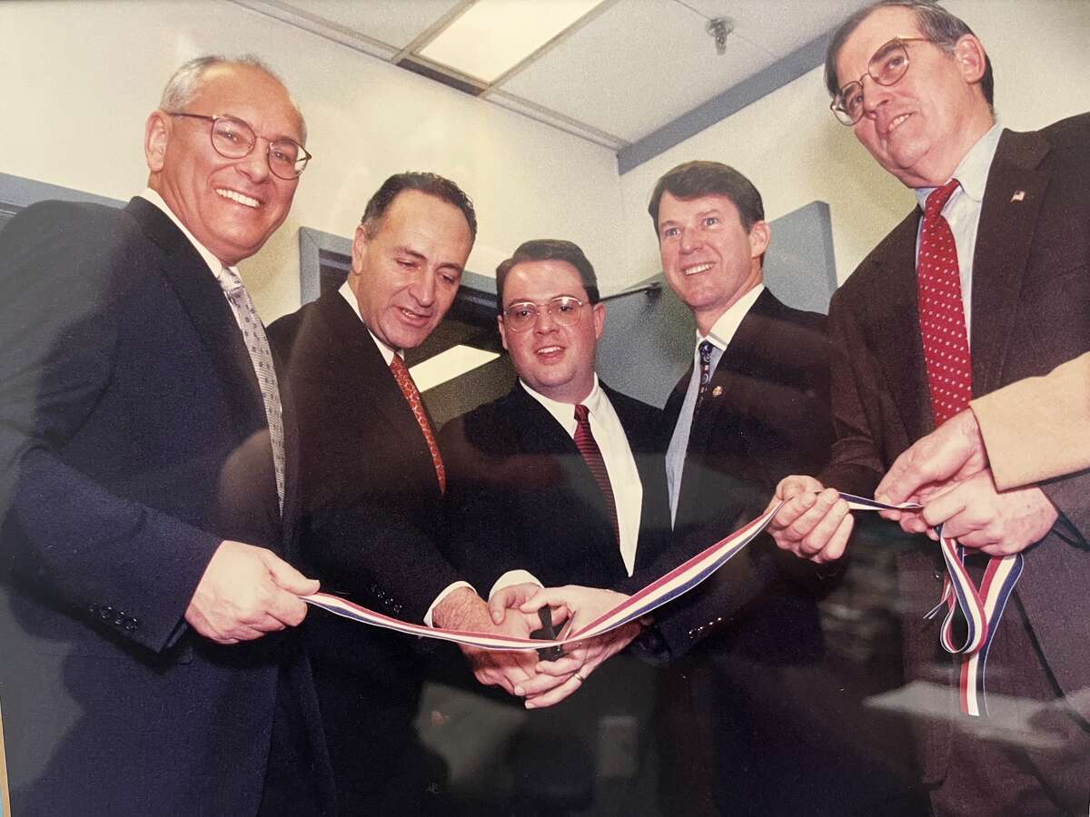 Steve Mann, center, cuts a ribbon to open an Albany office newly elected U.S. Sen. Chuck Schumer, D-New York. With Albany lawmakers, from left, Paul Tonko, Schumer, Michael McNulty and Michael Breslin. (Photo provided by Steve Mann)