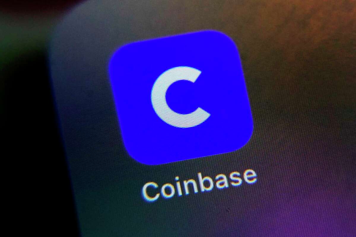 Coinbase, the company’s mobile phone icon shown in this photo, is cutting approximately 950 jobs, or 20% of its workforce, in a second round of layoffs.