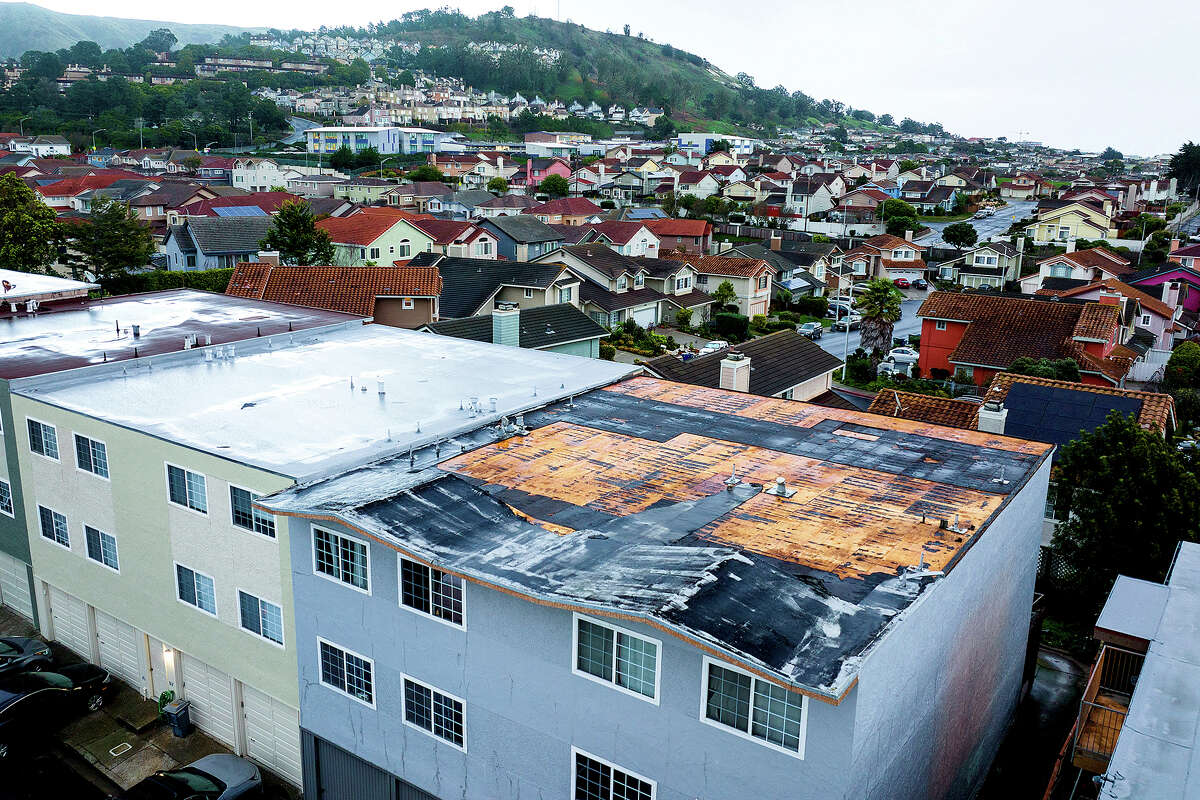 Exposed roofing tops a South San Francisco, Calif., apartment building as storms continue battering the state on Tuesday, Jan. 10, 2023.