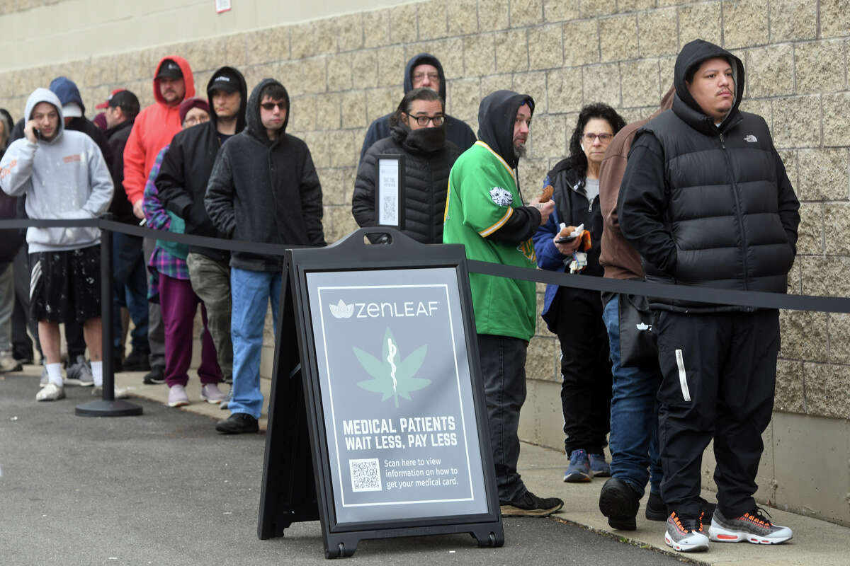 Customers wait in line on the first day of recreational marijuana sales at Zen Leaf Meriden, in Meriden, Conn. Jan. 10, 2022.