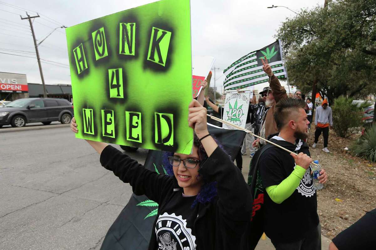 Arianna Casillas, in the foreground, joins a crowd supporting the legalization of cannabis in Texas gathered on Feb. 10, 2018, at the intersection of San Pedro Avenue and West Rector Drive in San Antonio.