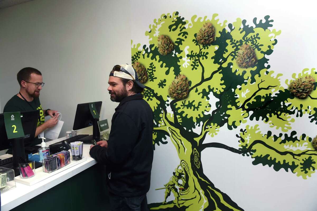 Personal Care Specialist Nick Decio, left, fulfills a cannabis order for Justin Swanson of Branford at Rise in Branford on the first day of recreational cannabis sales Tuesday.