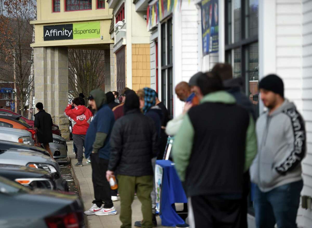 People stand in line at the Affinity Health and Wellness dispensary on Whalley Avenue in New Haven before the opening time on the first day of recreational cannabis sales  Jan. 10.
