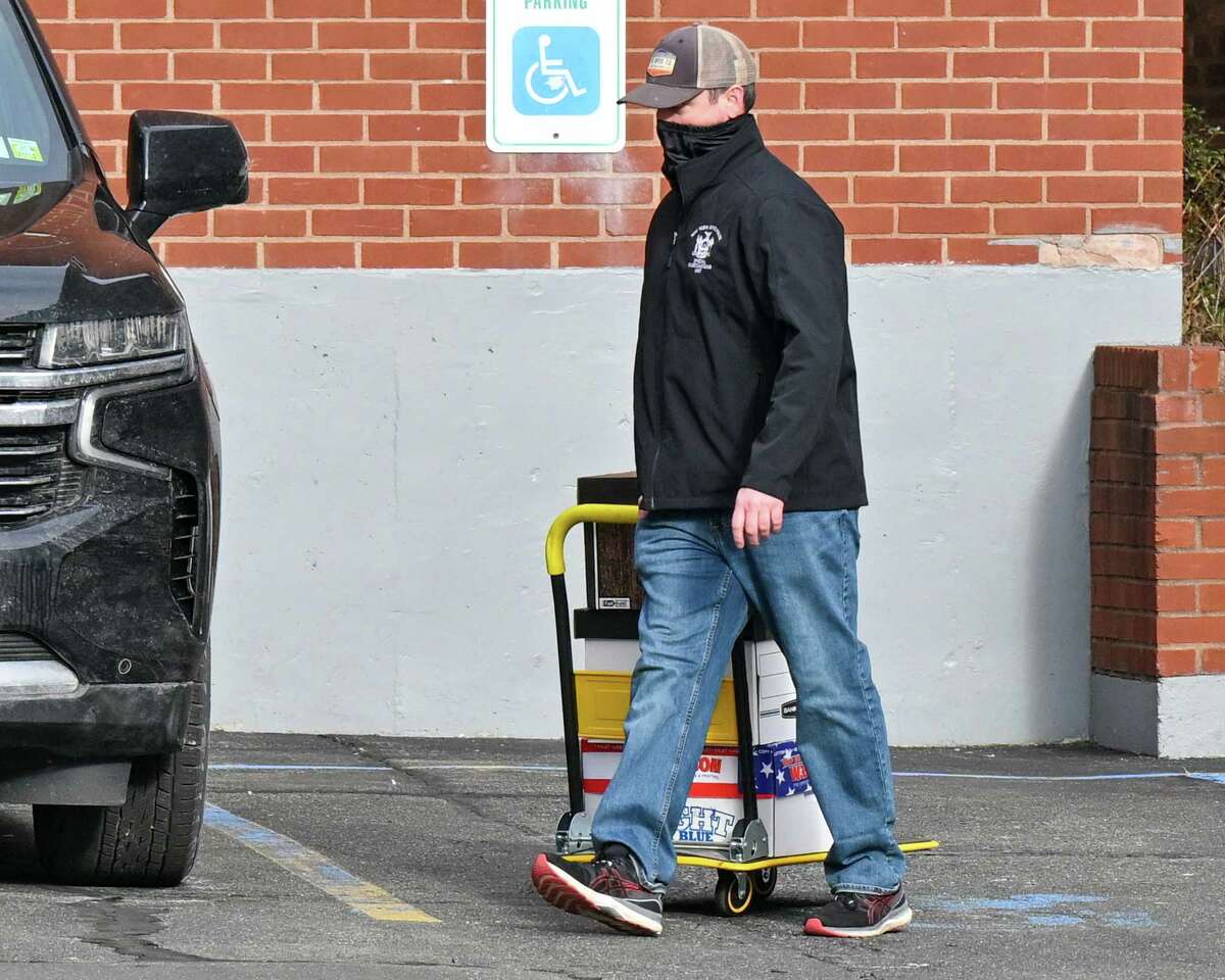 A member if the State Police Special Investigations Unit removes boxes of records from the New York State Troopers Police Benevolent Association on Tuesday, Jan. 10, 2023, on Howard Street in Albany, NY. The SIU executed search warrants at the PBA’s headquarters and the adjacent office of the Signal 30 Benefit Fund, a non-profit associated with the union.