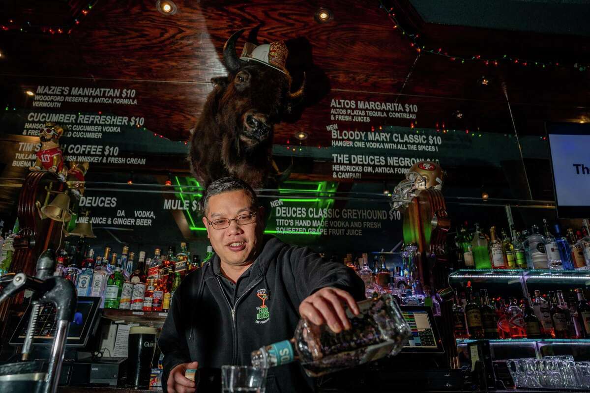 Marcus Gunn pours a drink for a customer at the Four Deuces.