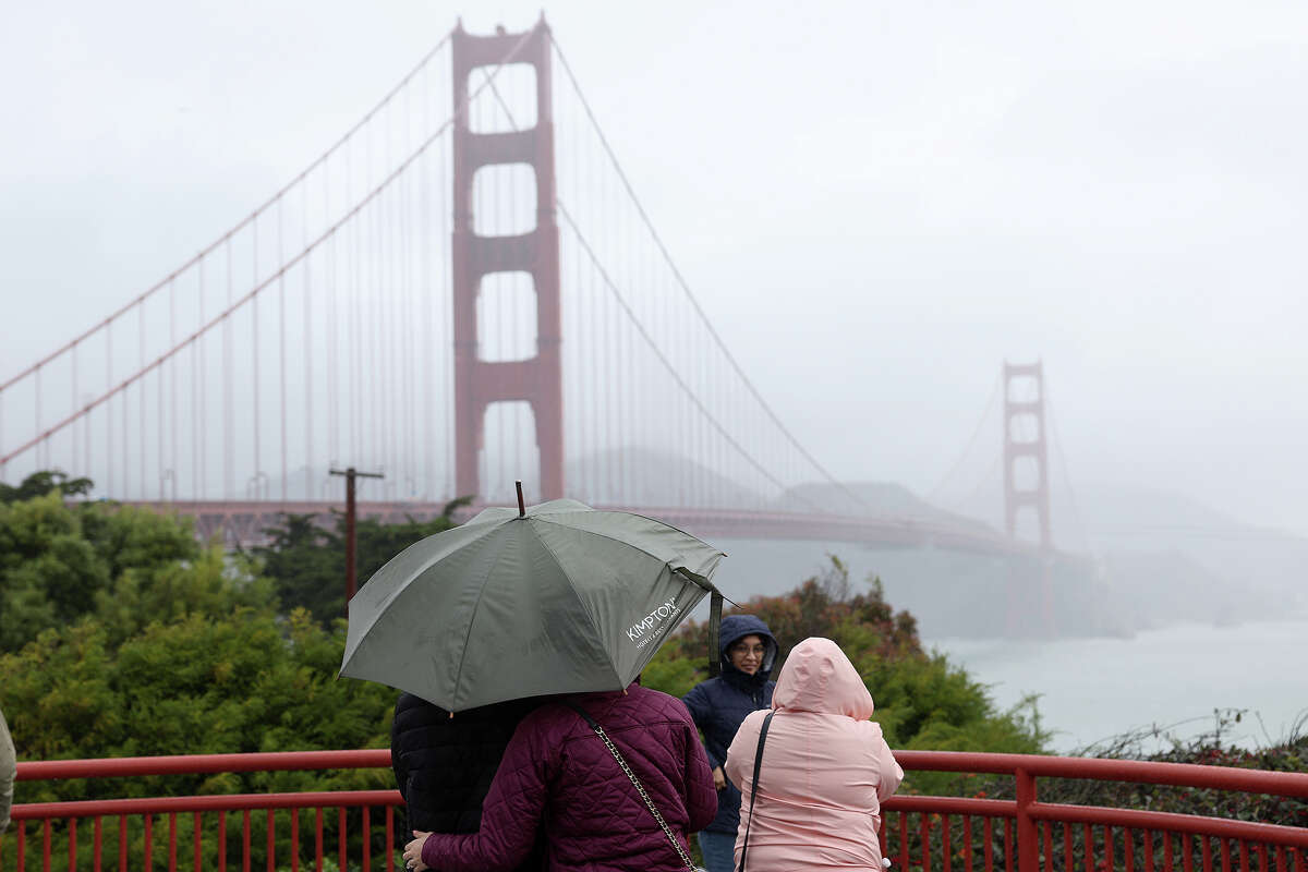People visit the Golden Gate Bridge as a rainstorm moves through the area on Jan. 4 in San Francisco. The Bay Area is expected to see two rounds of rain this weekend.