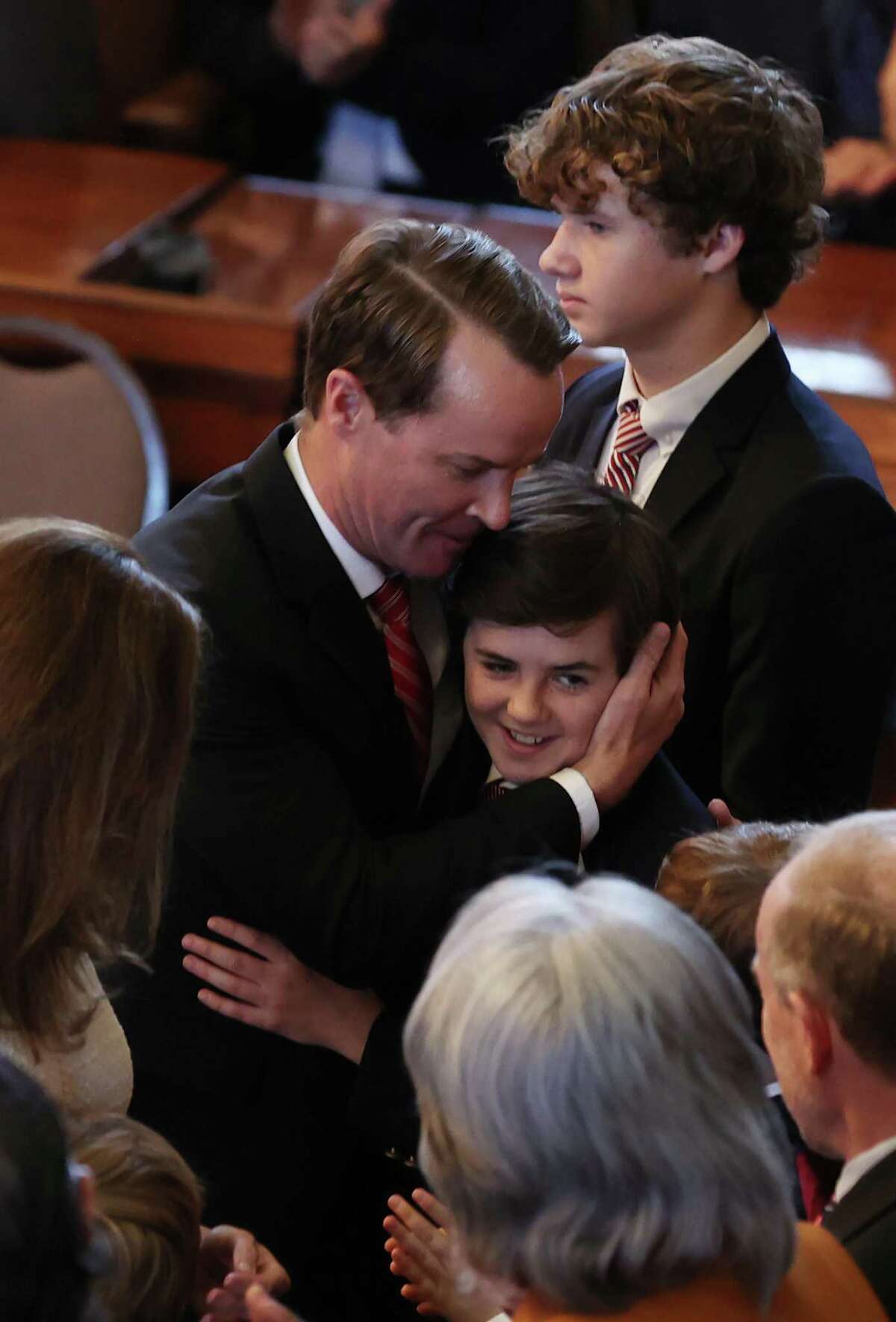 Texas State Rep. Dade Phelan hugs his sons after he was sworn in as Speaker of the House for the 88th Legislature at the State Capitol, Tuesday, Jan. 10, 2023.