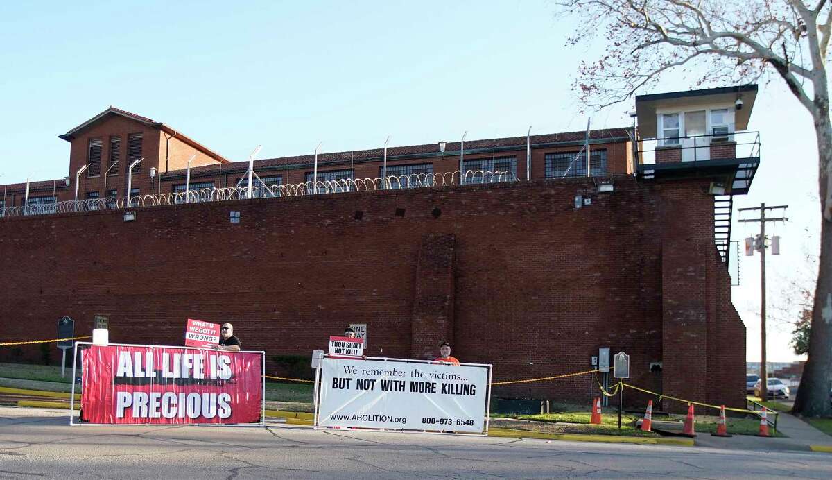 Four protesters stand outside before Robert Fratta’s scheduled execution at the Texas State Penitentiary Walls Unit on Tuesday, Jan. 10, 2023 in Huntsville. Fratta a former police officer, was convicted in the 1994 death of his estranged wife, 33, in a murder-for-hire plot he orchestrated.