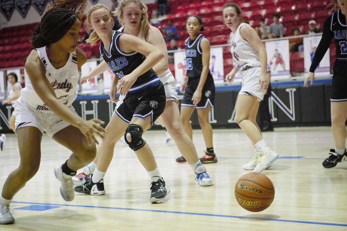 Midland Christian's Amara Odukwu and Fort Worth Southwest Christian's Rachel Swenson go for a loose ball during a TAPPS 1-5A girls basketball game, Jan. 10 at McGraw Event Center. 